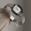 A delicate blend of modern elegance and vintage charm, this silver sparkle oval women's watch is designed to make a subtle yet striking statement. Featuring a polished oval case and a minimalist white dial, the design is elevated by a shimmering textured strap that catches the light beautifully with every movement.
