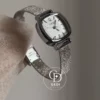 A delicate blend of modern elegance and vintage charm, this silver sparkle oval women's watch is designed to make a subtle yet striking statement. Featuring a polished oval case and a minimalist white dial, the design is elevated by a shimmering textured strap that catches the light beautifully with every movement.